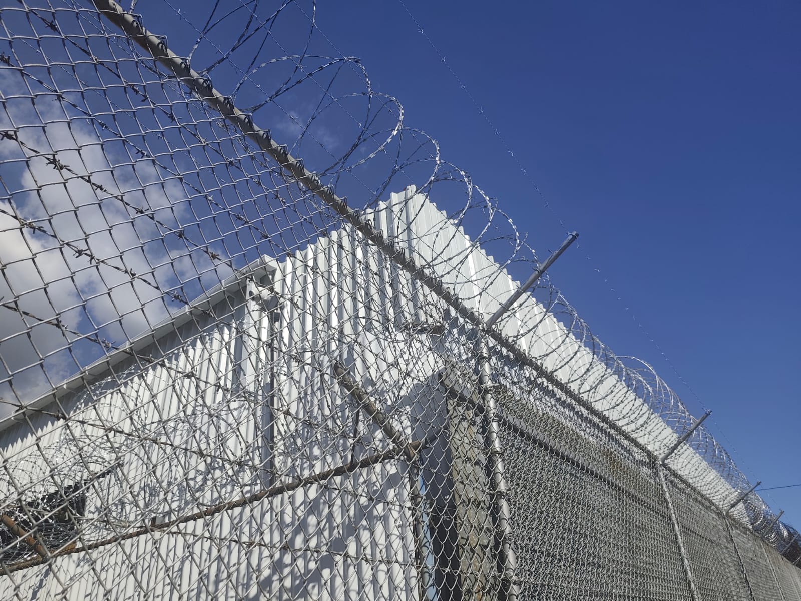 Security fence with barbed wire